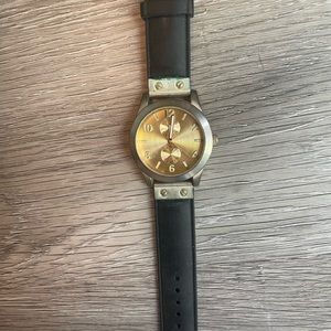 Women’s watch gold face black band